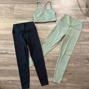 Sage Collective green sports bra and matching leggings plus black leggings.